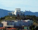 A modern building with the Pena Palace in the background